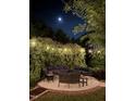 Tranquil outdoor patio illuminated by string lights, offering a serene space for evening relaxation and gatherings beneath the moonlight at 300 Lakeside Dr, Garner, NC 27529