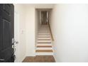 Inviting entryway featuring hardwood flooring and a staircase leading to the upper level at 335 Bridgegate Dr, Cary, NC 27519