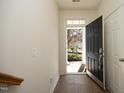 Bright foyer with tile flooring and view of the front yard through an open front door at 335 Bridgegate Dr, Cary, NC 27519