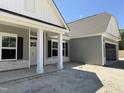 A beautifully landscaped exterior with white columns highlights the home's entryway and attached garage at 4013 Kingcraig Ln, Zebulon, NC 27597