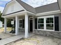Inviting front entrance with classic columns, detailed stonework, and a well-designed doorway enhancing curb appeal at 4013 Kingcraig Ln, Zebulon, NC 27597