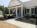 Inviting entrance with manicured landscaping and stone accents on a charming single-story home at 4013 Kingcraig Ln, Zebulon, NC 27597