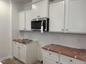 New kitchen with white cabinets, stainless steel microwave, and stylish backsplash at 4013 Kingcraig Ln, Zebulon, NC 27597