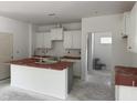 Bright kitchen with white cabinets, a central island, and plenty of space, perfect for cooking and gathering at 4013 Kingcraig Ln, Zebulon, NC 27597