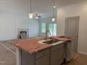 Bright, open-concept kitchen with modern fixtures and an island, adjacent to the spacious living area at 4013 Kingcraig Ln, Zebulon, NC 27597