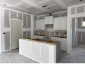 Bright kitchen features white cabinets and a center island, ready for customization at 4013 Kingcraig Ln, Zebulon, NC 27597