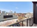 Stunning balcony view overlooking a vibrant city skyline and charming residential neighborhood at 402 Chavis Way, Raleigh, NC 27601