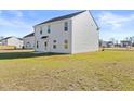 Spacious backyard with ample green space, showcasing the home's exterior and neighboring properties at 41 Alderman Ct # 2, Dunn, NC 28334