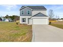 Charming two-story home with a two-car garage and neutral-toned siding at 41 Alderman Ct # 2, Dunn, NC 28334