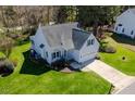 Aerial view of a charming home featuring a well-maintained lawn and an attached two-car garage at 4108 4108 Gallatree Ln, Raleigh, NC 27616