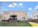 Spacious backyard with a deck, patio, and manicured lawn at 4619 Paces Ferry Dr, Durham, NC 27712