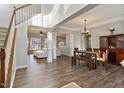 Bright and airy living room with hardwood floors, large windows, and a cozy seating area at 4619 Paces Ferry Dr, Durham, NC 27712