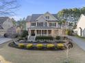 Charming two-story home with a covered front porch and well-manicured landscaping in a suburban setting at 512 Hallburg Ct, Wake Forest, NC 27587