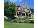 Charming two-story home with a welcoming front porch and beautifully landscaped front yard at 512 Hallburg Ct, Wake Forest, NC 27587