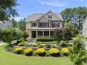 Beautiful two-story home with a charming front porch and professionally landscaped front yard at 512 Hallburg Ct, Wake Forest, NC 27587