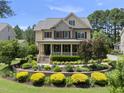 Attractive two-story home featuring a covered front porch and meticulously maintained landscaping at 512 Hallburg Ct, Wake Forest, NC 27587