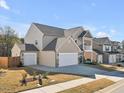 Spacious two-story home with a three-car garage and manicured lawns, offering ample parking and curb appeal in a modern setting at 524 Glenwyck Ct, Fuquay Varina, NC 27526