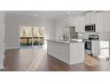 Bright kitchen with stainless steel appliances, granite counters, and backyard view at 5320 River Reach Dr, Raleigh, NC 27616