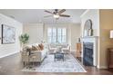 Bright living room with a cozy fireplace, elegant decor, and hardwood floors, perfect for relaxing and entertaining at 590 Grand Central Sta, Apex, NC 27502