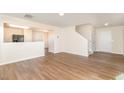Spacious living area with hardwood floors, leading to the staircase and front door at 627 Hastings Rd, Mebane, NC 27302