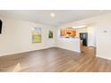 Open concept living room with hardwood floors, flowing into a modern kitchen at 627 Hastings Rd, Mebane, NC 27302