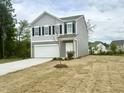 Two-story home with grey siding and a two car garage at 736 Kenyon Spring Dr, Zebulon, NC 27597