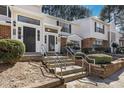 Home exterior showcasing light siding, brick accents, and maintained landscaping up to the entrance at 7706 Falcon Rest Cir, Raleigh, NC 27615