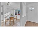 Bright kitchen nook with tile flooring, white cabinetry, and a cozy dining area near the door at 7727 Ohmann Ct, Raleigh, NC 27615