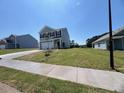 A lovely two-story home with a manicured lawn under a clear blue sky at 837 Kenyon Spring Dr, Zebulon, NC 27597