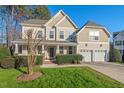 Charming two-story home with a manicured front yard and a two-car garage offers great curb appeal at 9 Water Stone Ct, Durham, NC 27705