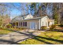 Well-maintained home featuring a covered porch, double front doors, and a spacious driveway at 901 Emory Ln, Raleigh, NC 27609