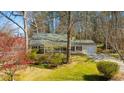 Charming single-story home featuring well-manicured lawn and beautiful landscaping at 901 Emory Ln, Raleigh, NC 27609