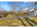 Spacious front yard with mature trees and driveway leading up to the home at 901 Emory Ln, Raleigh, NC 27609