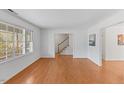 Spacious living room with hardwood floors and large windows, offering ample natural light and a view of the outdoors at 901 Emory Ln, Raleigh, NC 27609