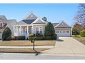 Charming single-story home featuring a well-manicured lawn, covered porch and attached garage at 922 Tupelo Glen Ct, Fuquay Varina, NC 27526