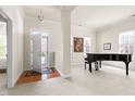Bright foyer featuring a grand piano, hardwood floors and an abundance of natural light at 922 Tupelo Glen Ct, Fuquay Varina, NC 27526