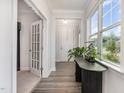 Bright foyer with natural light, hardwood floors, and views to front door and other rooms at 101 Maroon Ct, Raleigh, NC 27610