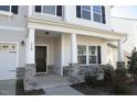 Close-up of the front porch, showcasing stone accents and a black front door at 110 Manor Stone Dr, Clayton, NC 27527
