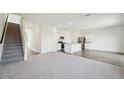 Open concept living space with carpeted floors adjacent to the kitchen at 1140 Centerview Drive, Nashville, NC 27856