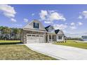 Beautiful home with two car garage, stone accents, and a long driveway at 115 S Harper Faith Way, Benson, NC 27504