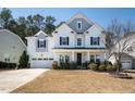 Charming two-story home featuring a manicured lawn and an attached two-car garage at 117 Gravel Brook Ct, Cary, NC 27519
