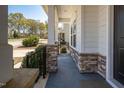 Inviting front porch with stone supports and a dark grey painted floor at 117 Gravel Brook Ct, Cary, NC 27519