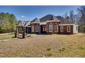 Charming brick home showcases symmetrical design, a gabled roof, and manicured lawn at 119 Cardinal Crest Ct, Pittsboro, NC 27312