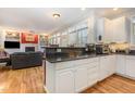 Open concept living area showcasing the kitchen, hardwood floors, and living room with fireplace at 12 Montcrest Dr, Durham, NC 27713