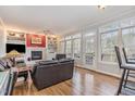 Inviting living room with a fireplace, built-in shelving, large windows, and hardwood floors at 12 Montcrest Dr, Durham, NC 27713