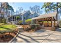 Charming home featuring a screened porch and covered parking surrounded by a well-maintained yard at 122 W Woodridge Dr, Durham, NC 27707