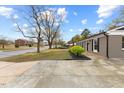 Charming single-story home featuring a paved driveway and manicured landscaping at 1230 Melrose Dr, Burlington, NC 27217