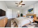 Bright bedroom with a ceiling fan, wood floors, and stylish furnishings at 125 Wynnridge Dr, Angier, NC 27501