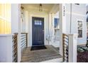 Inviting front porch with a swing and view of the front door of the house at 132 Fiori Hill S Dr, Hillsborough, NC 27278