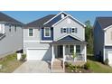 Beautiful two-story home featuring a cozy front porch, garage, and a well-maintained lawn at 1417 Underbrush Dr, Durham, NC 27703